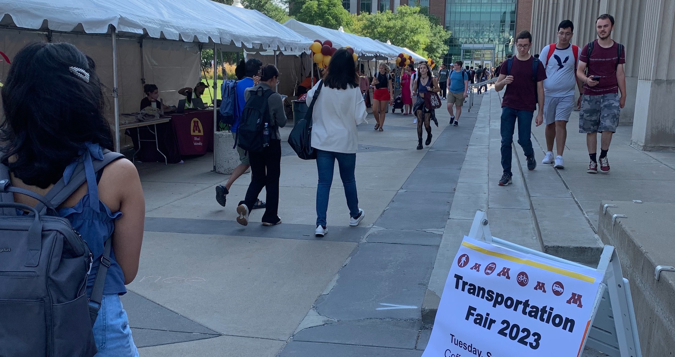 Students walking around different booths at the transportation fair